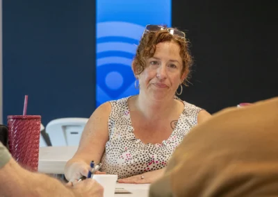 A participant listens attentively during the Lived Experience Committee meeting.